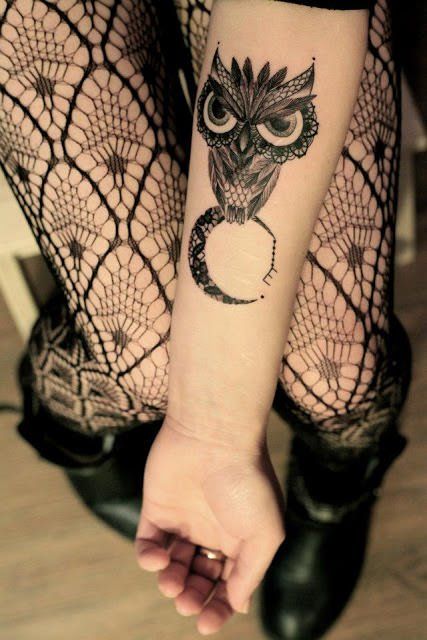 A grumpy owl sits on a lace moon in this creative tattoo for girls by Dodie