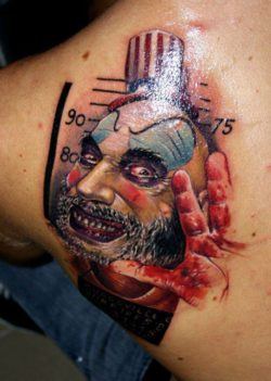 A nasty clown is the subject of this photo realistic surrealist tattoo by Asutrian tattoo studio Nadelwerk