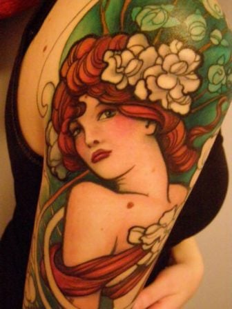 A stunning Jeff Gogue Art Deco tattoo of a pin up girl with flowers in her hair