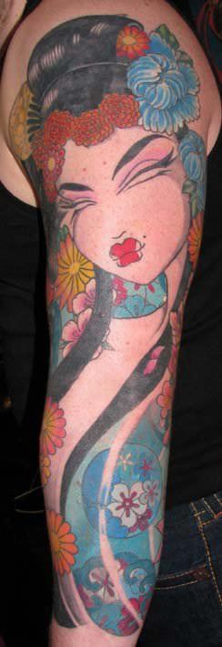 Flowers accentuate the beauty of this manga and Art Deco geisha tattoo by Venus Flytrap