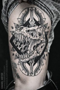 A dinosaur skull roars out from the center of a mandala design in this black ink tattoo design by Daniel Meyer