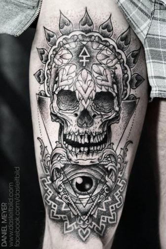 A human skull and eye are decorated with spiritual sacred geometry and mandalas in this tattoo by Daniel Meyer