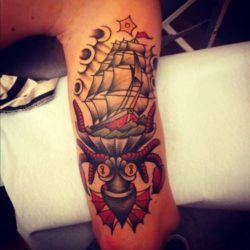 A monster octopus eats a ship at sea in this modern take of the American Traditional tattoo style by Karl Wiman