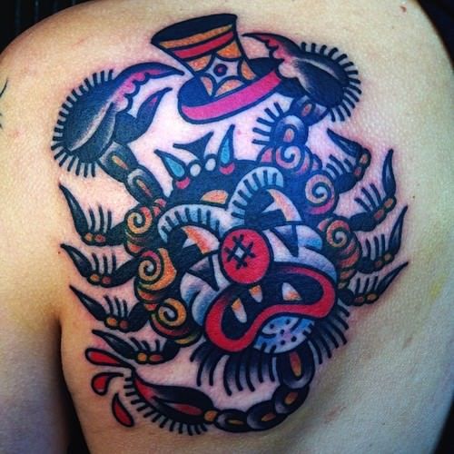 A scorpion and clown merge into one in this unusual old school tattoo by Karl Wiman