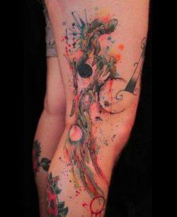 Abstract alien shapes take form in this artistic watercolor tattoo by Gene Coffey