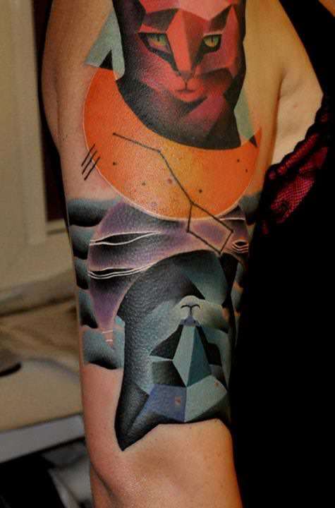 Cubist cats are tattooed in highly saturated colors in this abstract fine art tattoo by Marcin Surowiec