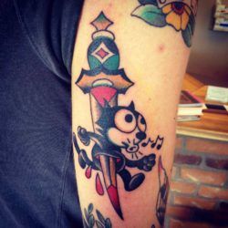 Felix the Cat is stabbed through by a dagger in this modern take on the American Traditional tattoo style by Karl Wiman