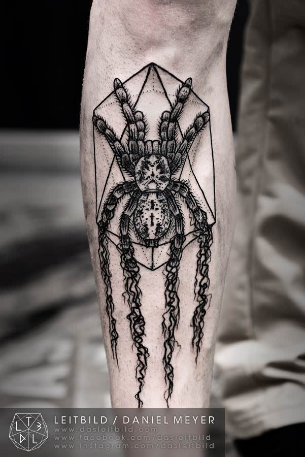 Tattoo artist Daniel Meyer has created a tarantula that dissolves while sitting on a geometric web