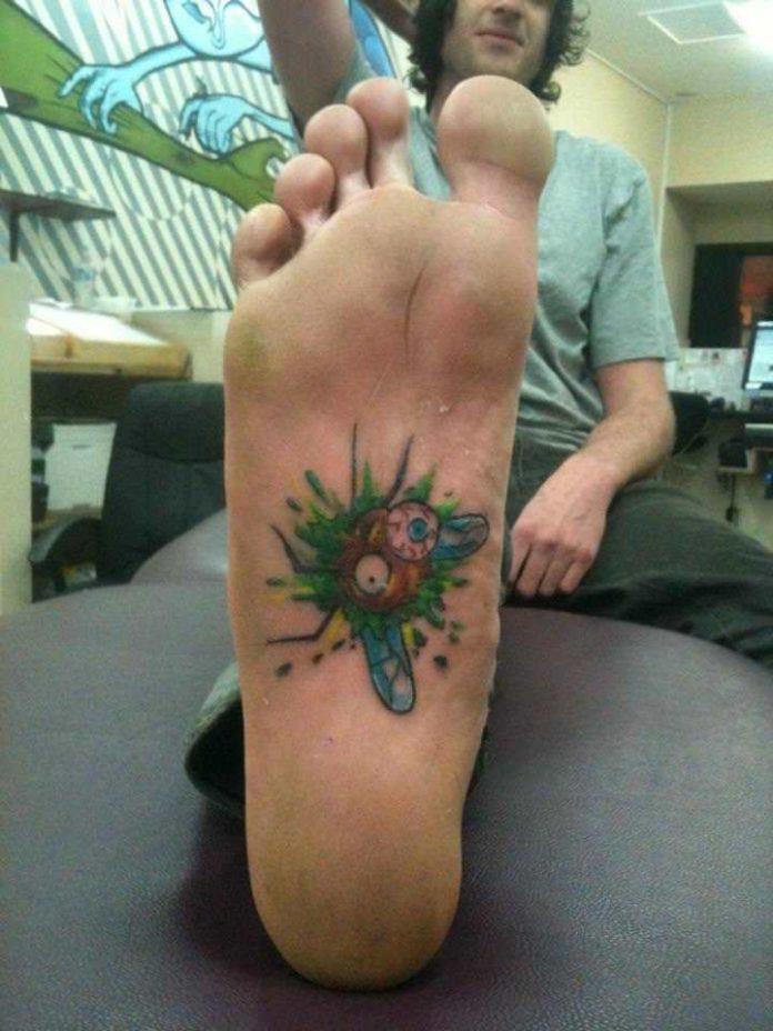 This funny tattoo design by Mel Wink shows a baug splattered on the sole of the clients foot