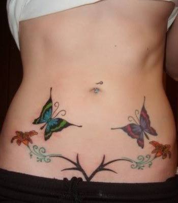 This picture of a belly tattoo of flowers and butterflies was taken before pregnancy
