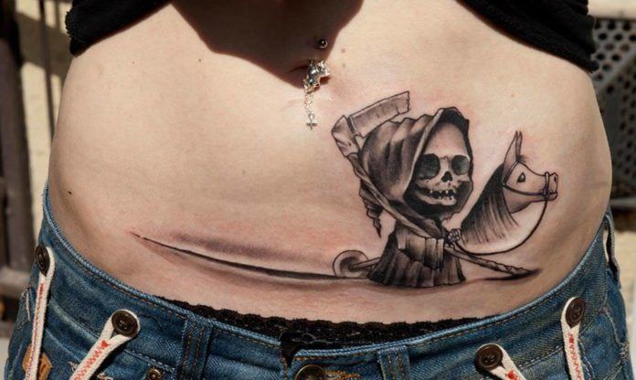 A black and white Death of Children walks along a Caesarean scar in this cute but creepy tattoo by Csiga