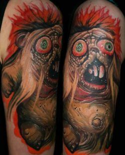 A horror bear gets a gory and colorful life on skin in this surrealist tattoo by Guil Zekri