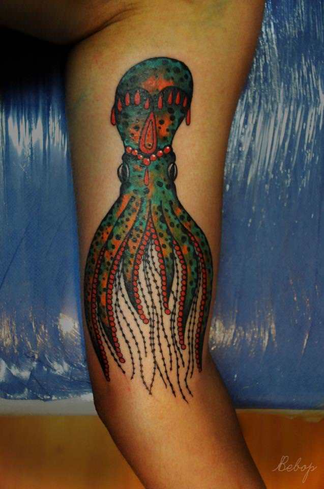 A squid takes on a decorative styling in this artistic animal tattoo by Karolina Bebop