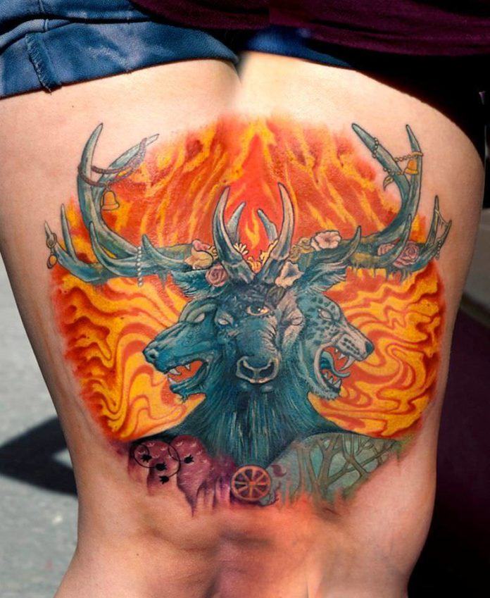 A stag with three heads stands before red flames in this fantasy tattoo by Csiga