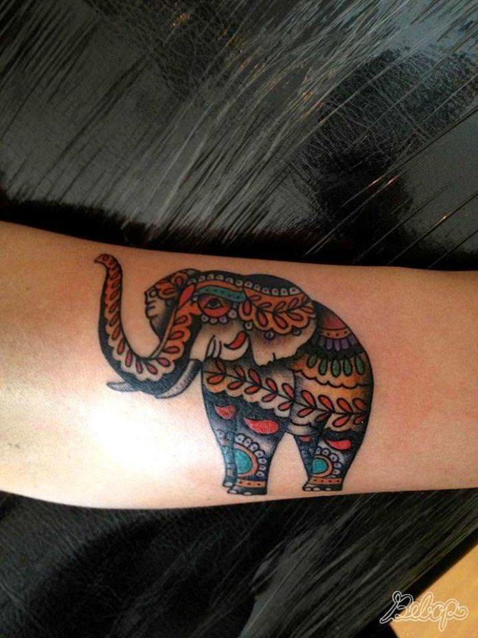 An elephant is decorated with paisley patterns in this decorative animal tattoo by Karolina Bebop