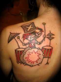French tattoo artist Noon creates a tough looking but fun drummer tattoo in an avante garde style