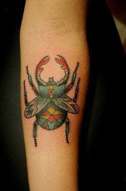 Karolina Bebop give a scarab beetle spiritual symbols in the form of sacred geometry and an all seeing eye