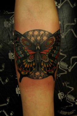 Karolina Bebop uses her crisp, bold style to give this butterfly surrounded by geometric shapes life on skin