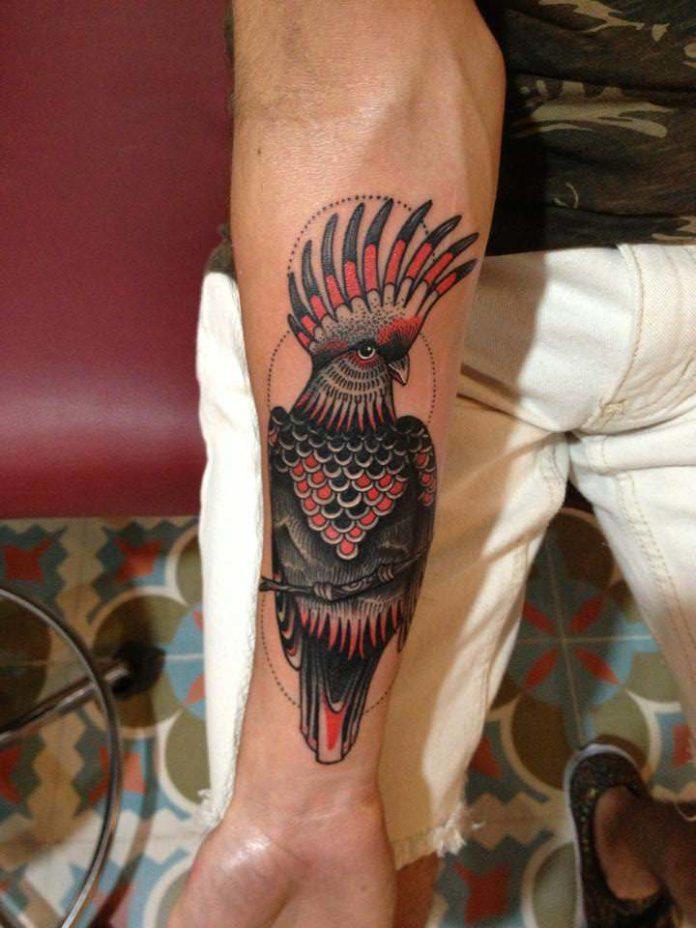 Textures and patterns abound in this black and red bird tattoo of a cockatoo by Karolina Bebop