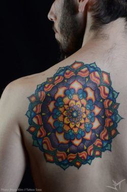 Sooz Tattooz a large and colorful mandala tattoo in the form of a sacred geometry flower of life