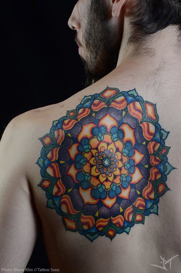 Sooz Tattooz a large and colorful mandala tattoo in the form of a sacred geometry flower of life