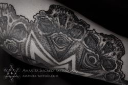 Tattoo artist Mika Amanita uses human skulls and eyes to build up this dotwork mandala tattoo design