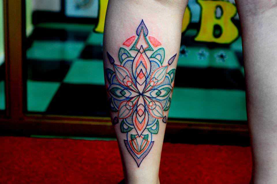 This sacred geometry mandala tattoo uses an elegant color palette and subtle textures to give the design visual appeal