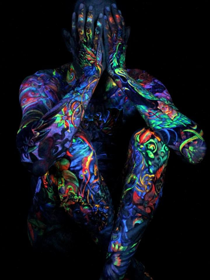 Under a blacklight, Glowrious Georges UV tattoos are so vivid that they look like body paint