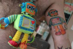 Matthew Bamber gets a tattoo of his sons favorite robot stuffed toy