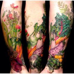 This tattoo by Butterfat studios features a bounty of fresh vegetables as a symbol of fertility and femininity