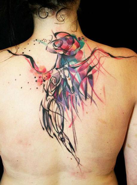 An abstract angel watches over this woman from within this watercolor tattoo by Petra
