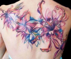 Exotic and imaginative flowers decorate this womans shoulders in a watercolor tattoo by Petra