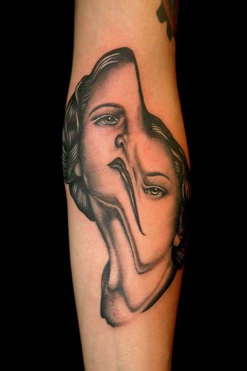 Pietro Sedda gives this portrait tattoo a twisted and psychological edginess by warping the woman's face