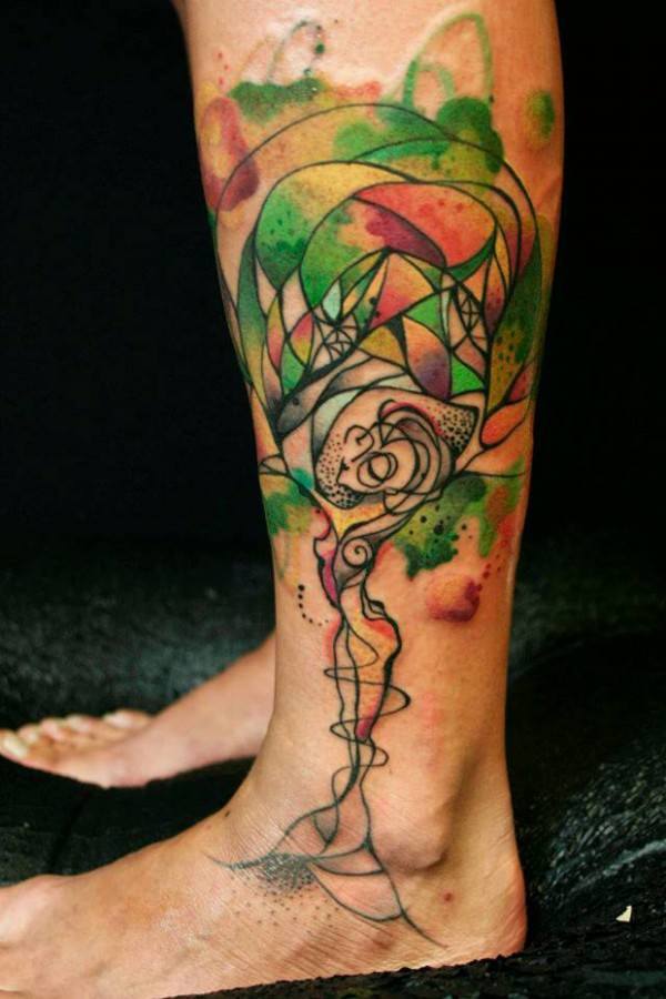 This beautiful tattoo by Petra shows a woman becoming a tree of life with colorful foliage and an elegant pose