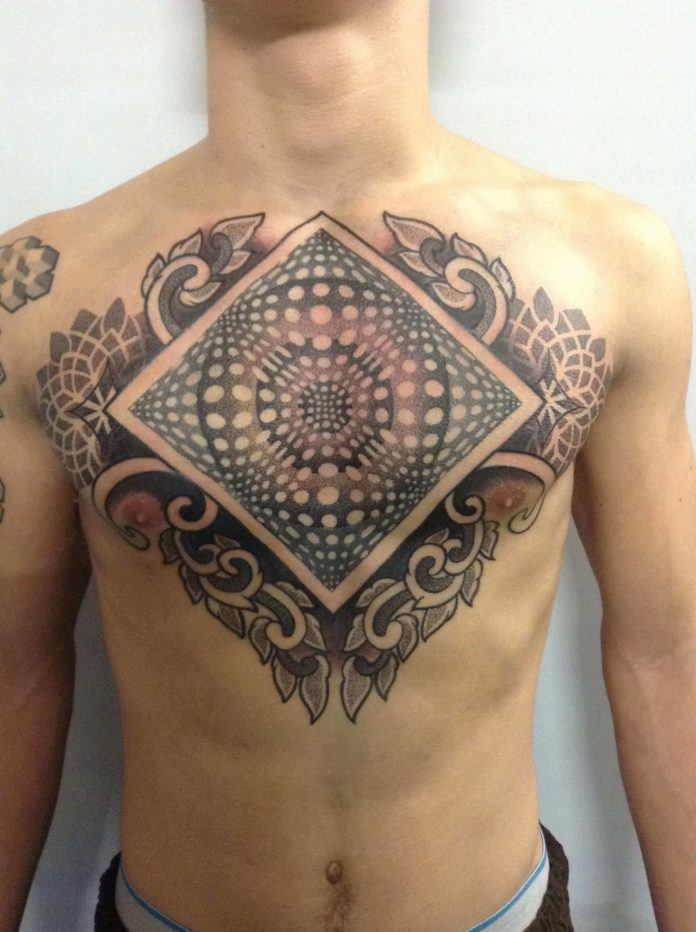 Deliperi has framed this optical illusion tattoo with floral designs to create a complex art work
