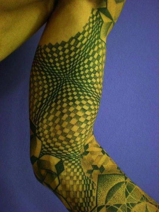 This incredibly hypnotic geometric tattoo by Pierluigi Deliperi uses checker patterns to create an optical illusion