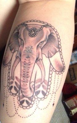An elephant adds his strength and wisdom to the symbolism of this Hamsa hand tattoo