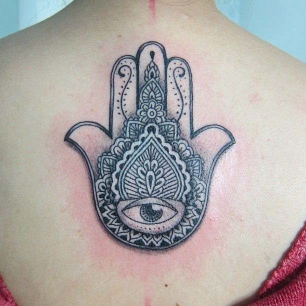 Paisley patterns surround the eye on the palm of this Hamsa hand tattoo