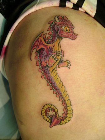 This cute cartoon tattoo of a baby dragon symbolizes the birth of power