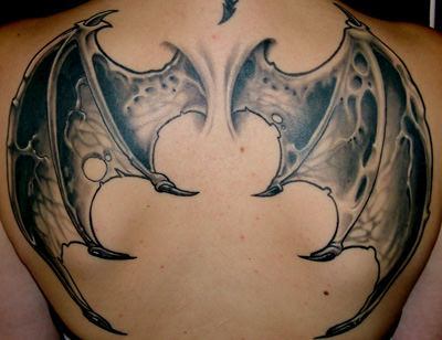 Dragon wings symbolize a love of freedom and flight in this back tattoo design