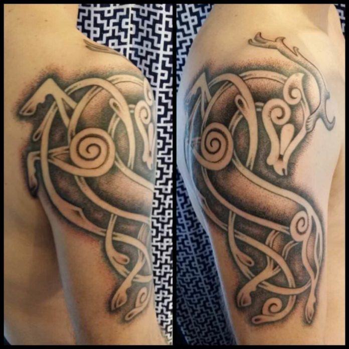 A viking era art style is used by Art on the Body tattoo studio in this tattoo of a leaping deer
