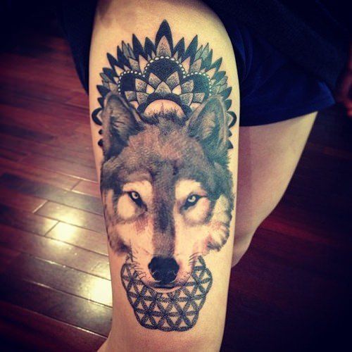 A wolf wears a mandala design as a spiritual crown in this decorative animal totem tattoo