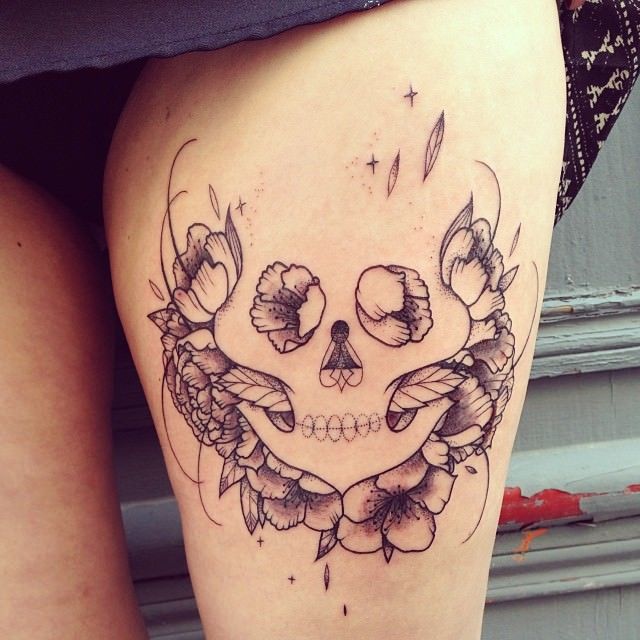 French artist Supakitch uses flowers and geometry to create the impression that a skull is hidden in this tattoo design