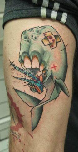 Mark Halbstark combines styles and symbolism in this abstract and surreal tattoo of a whale with human jaws