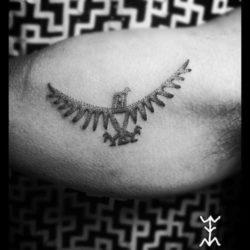 The dotwork texture of hand poked tattoos is apparent in this eagle tattoo on the bicep by Art on the Body tattoo studio in Copenhagen