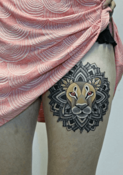 The lion totem in this meaningful tattoo design has a mandala for a mane