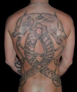 This full back tattoo by Art on the Body tattoo studio celebrates a scandinavian viking heritage by showing two dragons and celtic knots