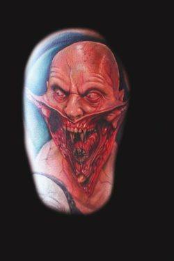 An alien humanoid reveals its freaky nature in this horror tattoo by Mario Hartmann