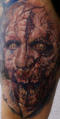 Creep yourself out with a horror tattoo like this rotting, hungry zombie tattoo by Mario Hartmann