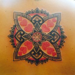 Italian tattoo artist Marco Galdo inserts red hearts into the petals of this mandala tattoo design